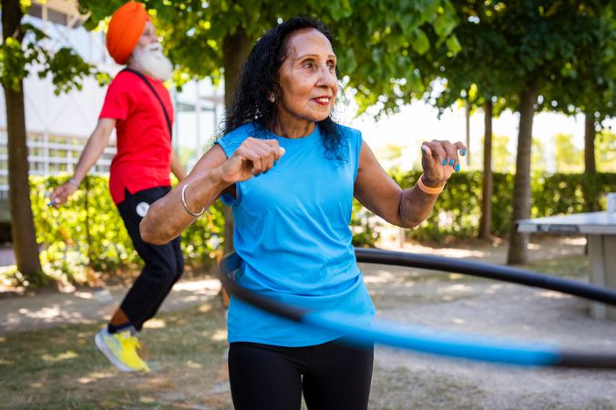 Mature Sikh couple exercising in public park