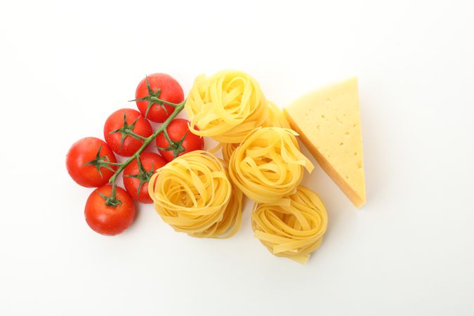 Tasty pasta and ingredients isolated on plain background