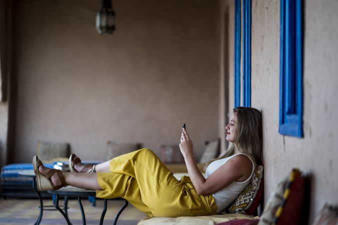 Woman with phone on oriental stone terrace