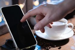 Browsing Smartphone in Cozy Workspace