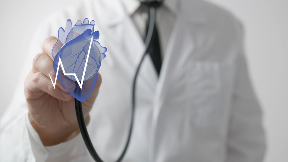Doctor uses stethoscope with heart hologram
