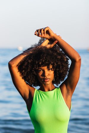 dreamy Black woman standing in sea during summer vacation