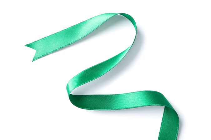 Green ribbon isolated on plain background. Gift concept