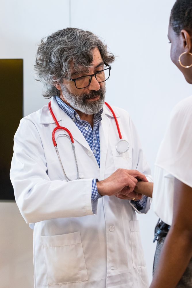 Doctor measuring pulse of patient