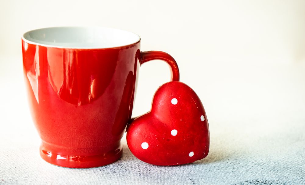 Red mug with dotted heart decoration for St. Valentine's day