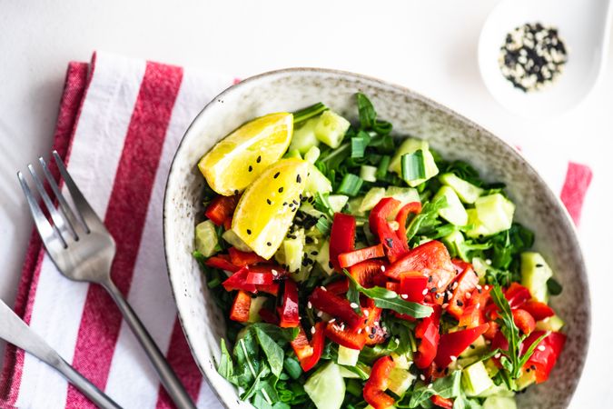 Top view of big grey bowl of delicious fresh salad