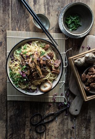 Miso noodles with egg plants and shiitake in bowl on table