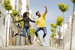 Excited couple jumping and taking selfie