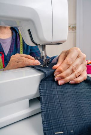 Seamstress hands working on a sewing machine