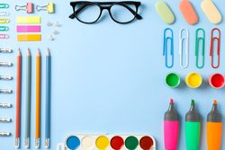 Flat lay composition with school supplies on color background, space for text