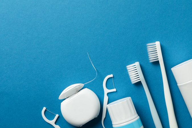 Tools for dental care on blue background, space for text