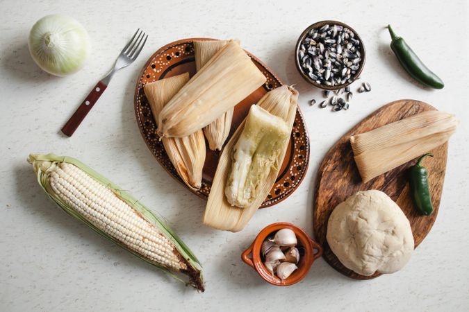Dough near corn husk and spices for tamales