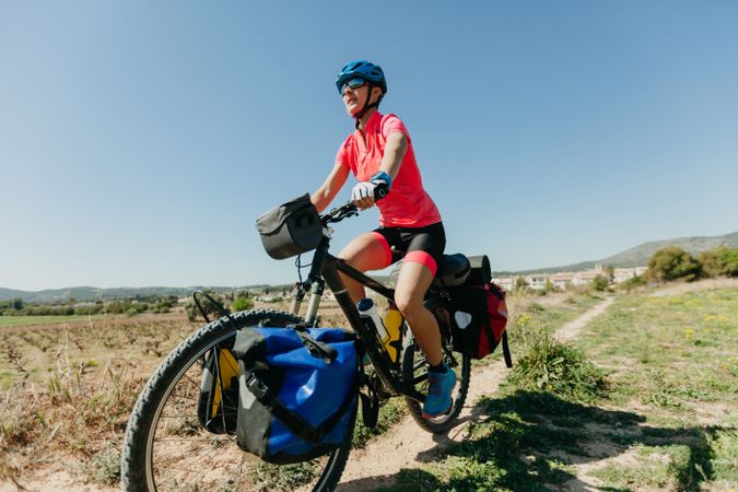 Woman riding bicycle in forest