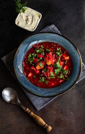 Ukrainian beetroot soup borscht on counter served with sour cream