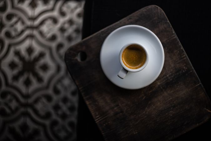 Top view of espresso cup on wooden tray