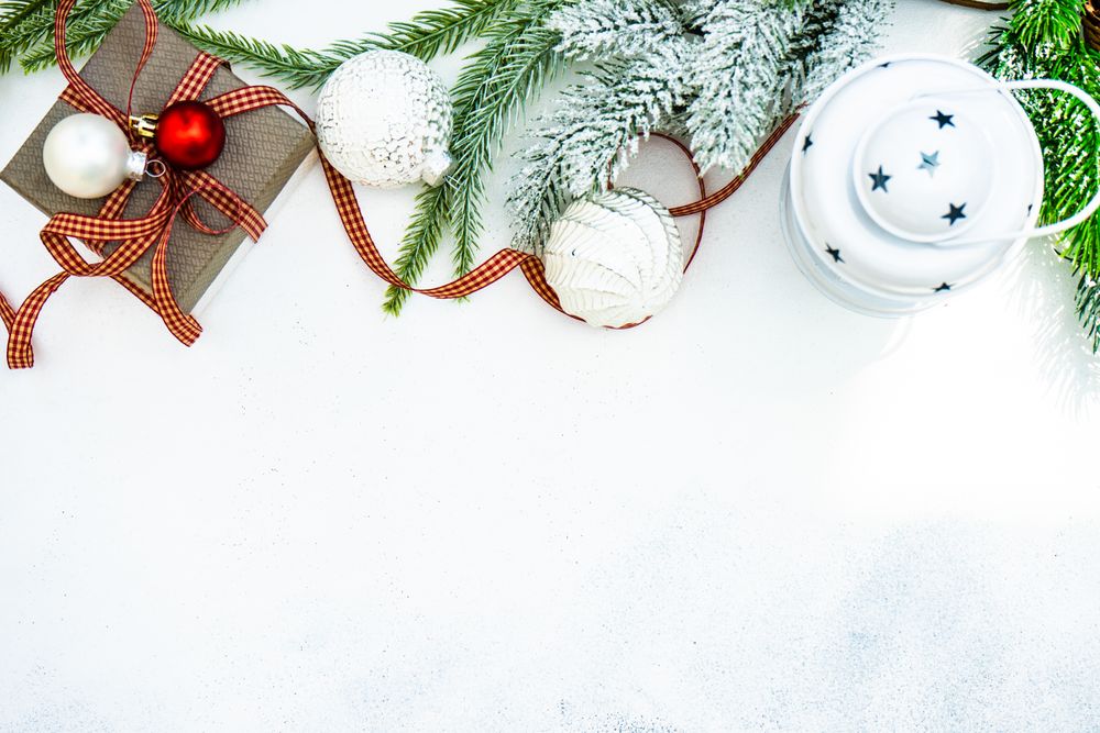 Christmas frame of decorations on snowy background