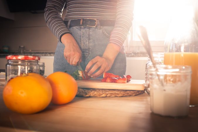 Woman cutting fruits in kitchen