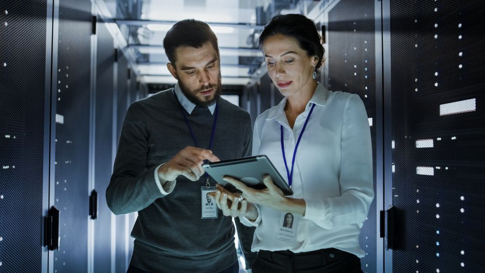 Male and Female IT Engineers in Data Center