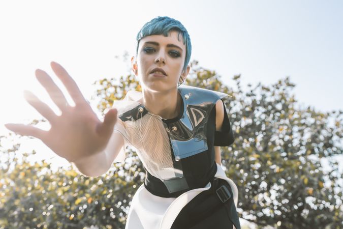 Futuristic woman reaching out camera