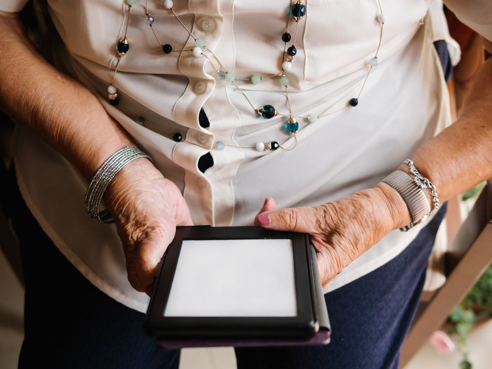 Older female reading e-book at home