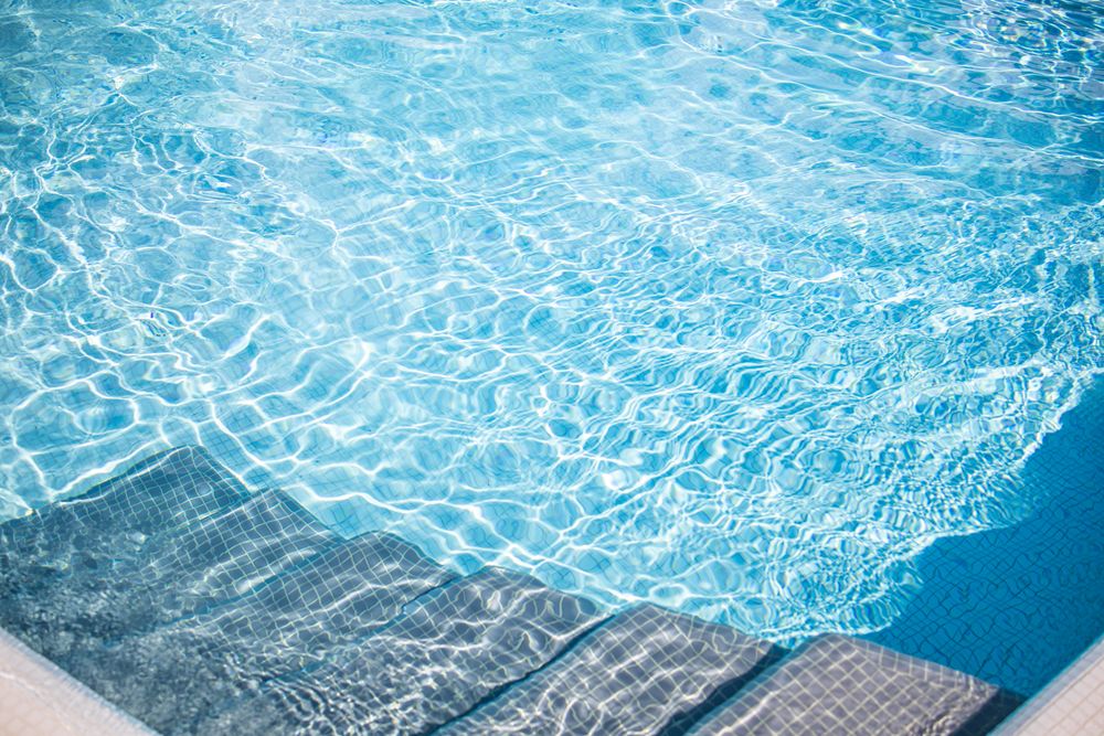 Stairs in a clear pool with ripples