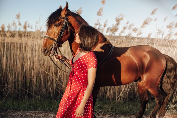 Young woman with horse on ranch
