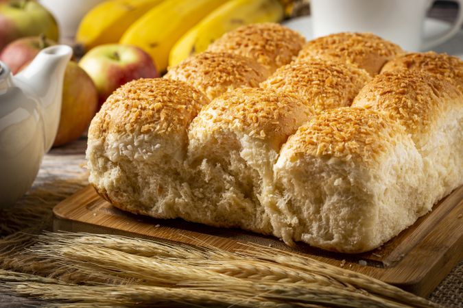 Breakfast table with coconut bread and fruits.