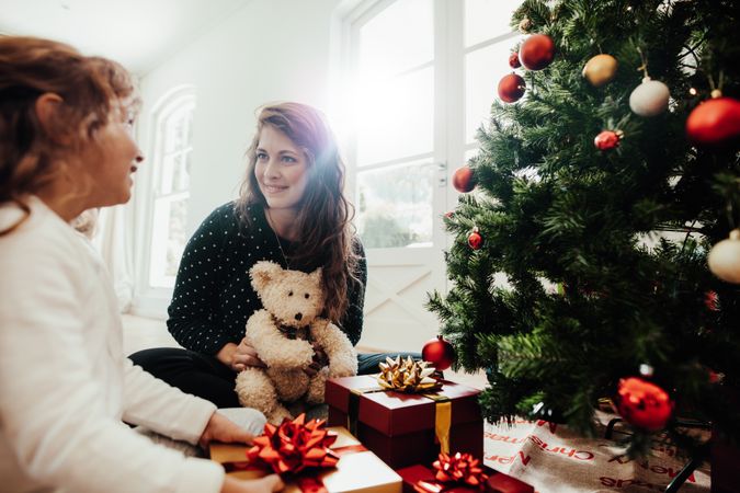Mother and daughter celebrating Christmas with lots of gifts