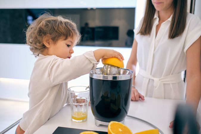 Mother and son making fresh juice at home