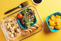 Plastic containers with healthy food and fork