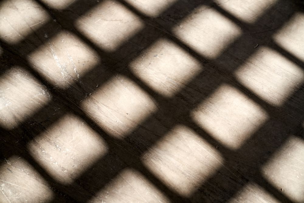 Shadow of window grid on floor in daylight