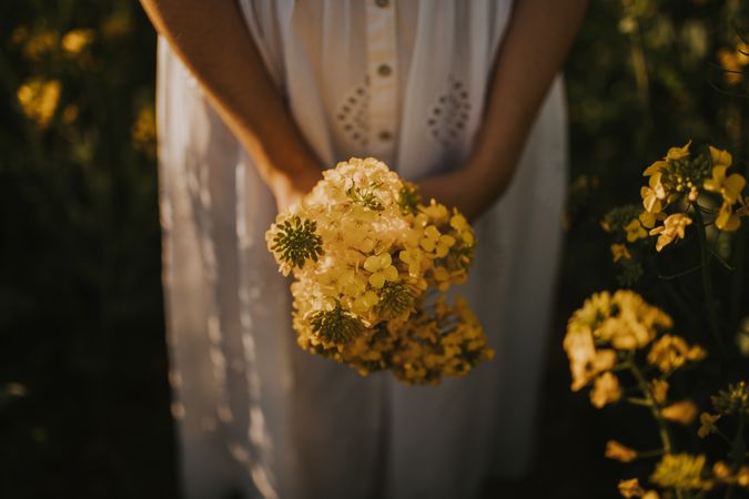 Woman with flowers in field