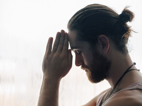 Man in mindfulness on window sill