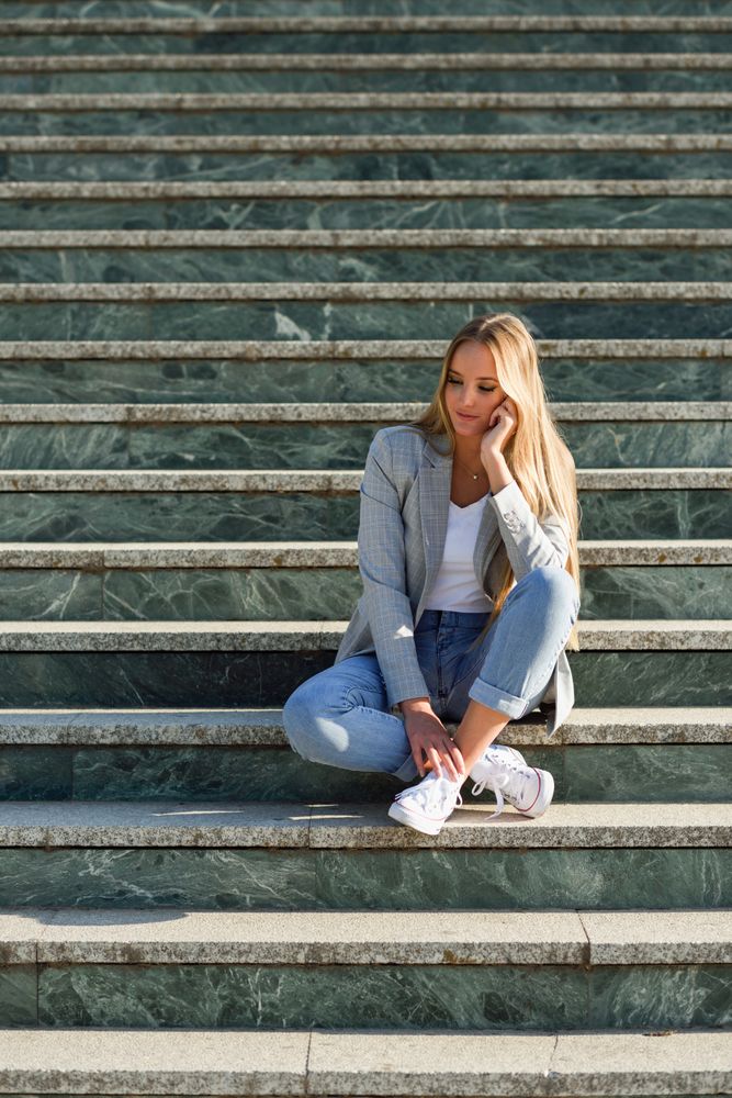 Woman sitting on steps in contemplation