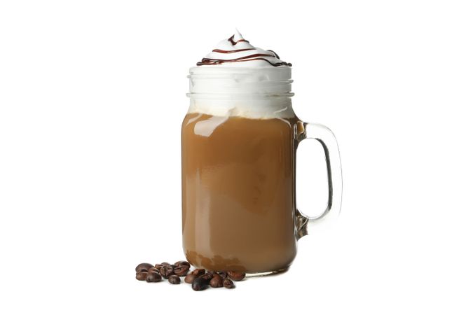 Iced coffee with poured cream isolated on plain background