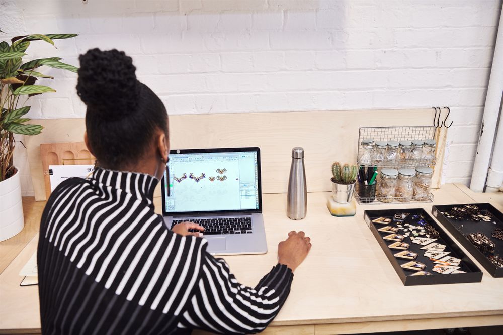 Jewelry designer working at a laptop