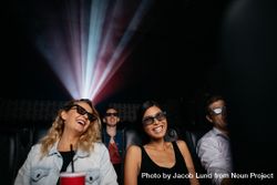 Young women watching 3d movie in cinema 0L3vXb