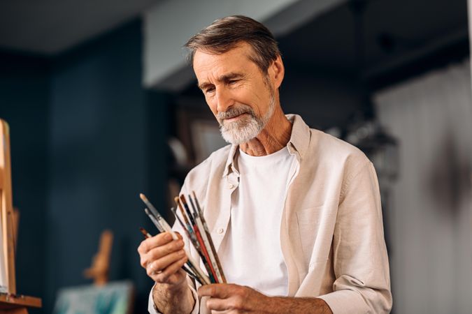 Male artist concentrating on his brushes