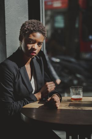 Smiling stylish Black woman in cafe