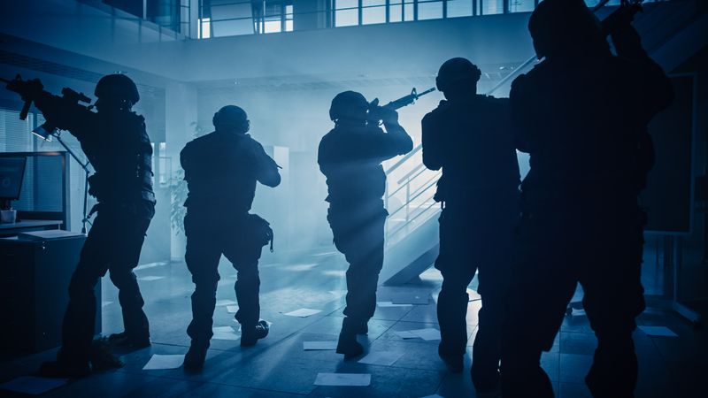 Soldiers with Rifles and Flashlights Move Forward and Cover Surroundings.
