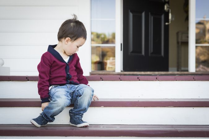 Toddler Boy Sitting on Front Porch Steps