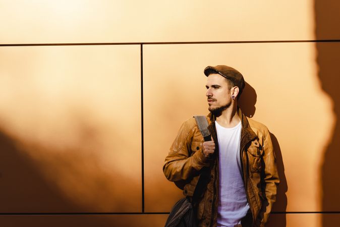 Confident guy leaning on wall