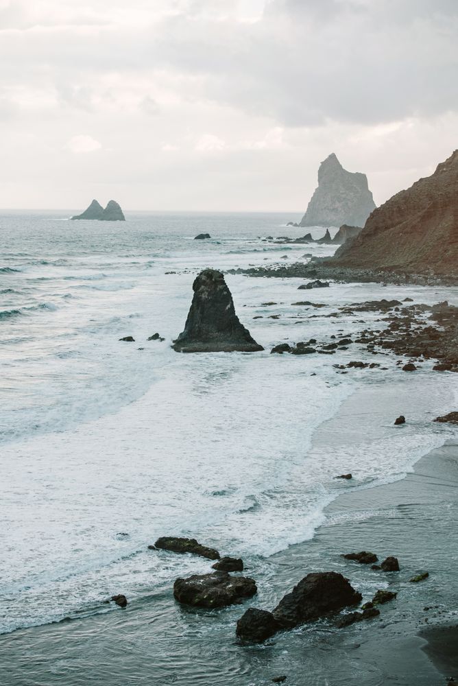 Lonely cliff in sea on cloudy day