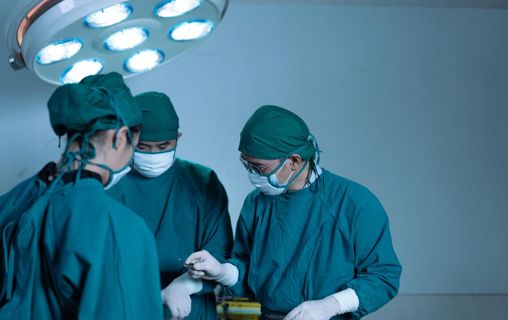 Surgical operation underway in hospital with medical professionals