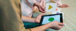 Female doctor showing geometric shapes to mature patient