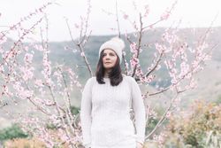 Pensive woman in spring countryside