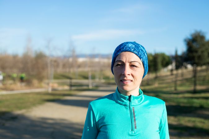 Woman in blue outdoors in park on sunny fall day