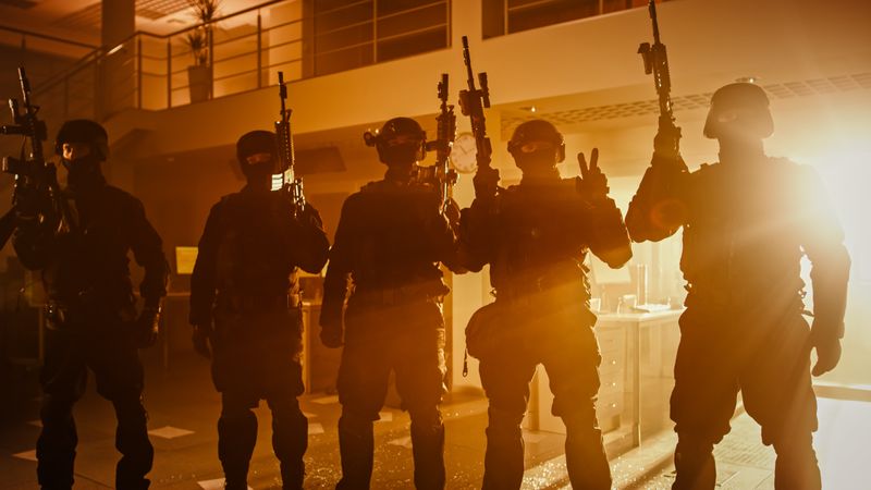 Masked Team of Armed SWAT Police Officers with Rifles are Posing After a Successful Office Building Siege