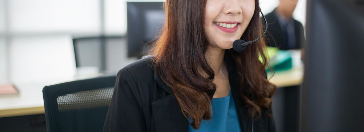 Banner of smiling woman at work wearing headset