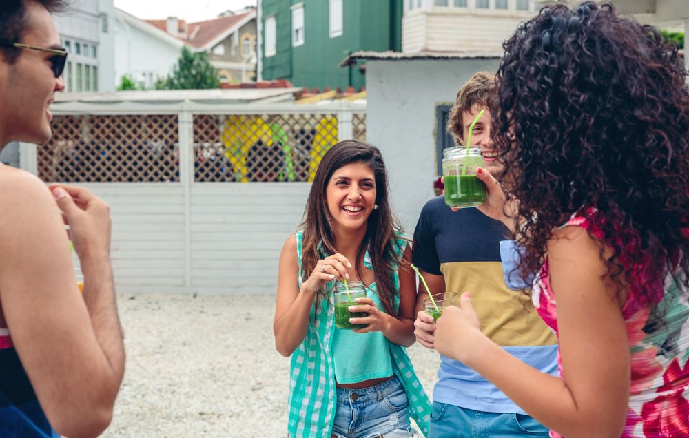 Friends enjoying cocktails in backyard
